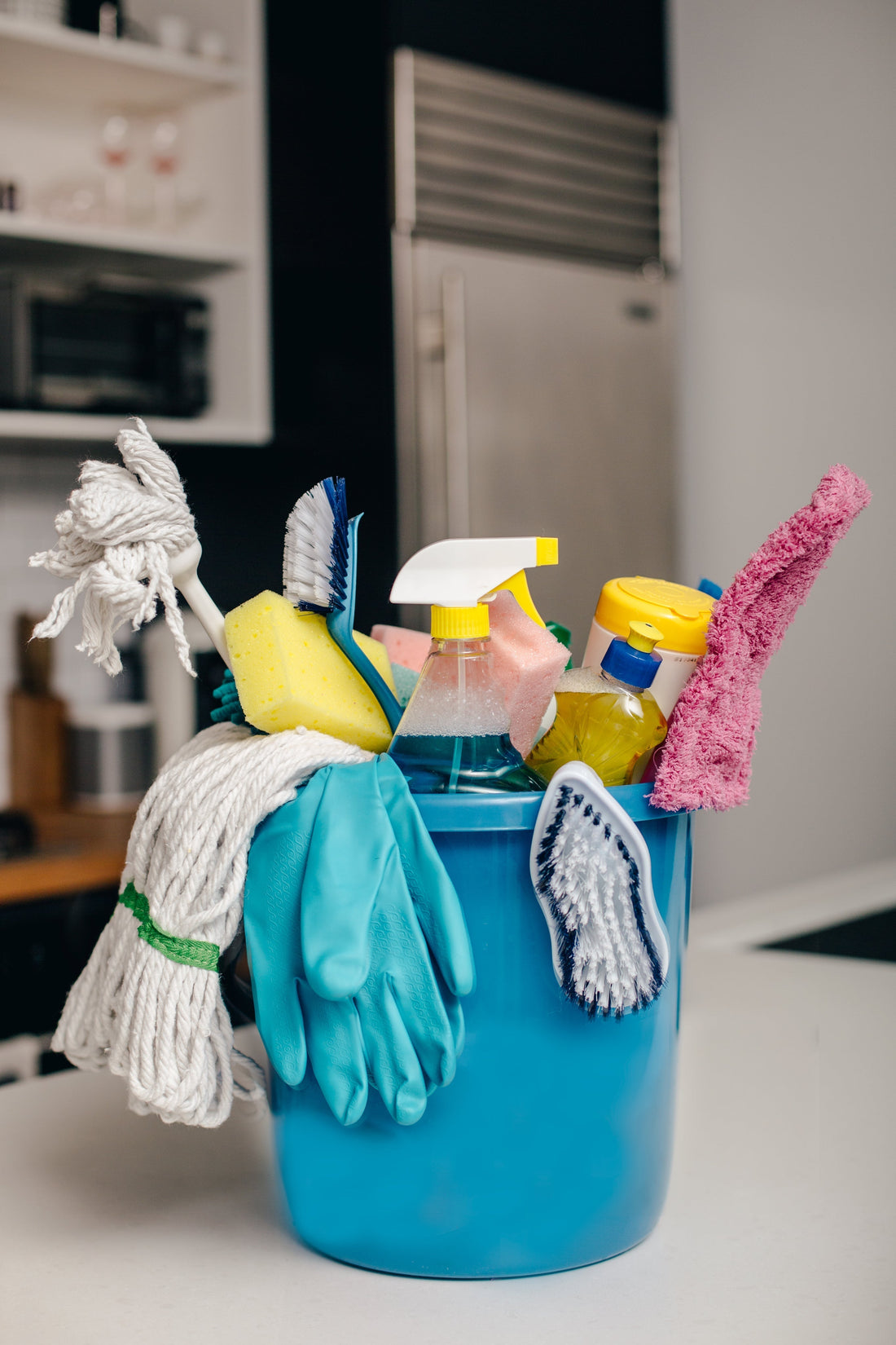 cleaning products in blue bucket 