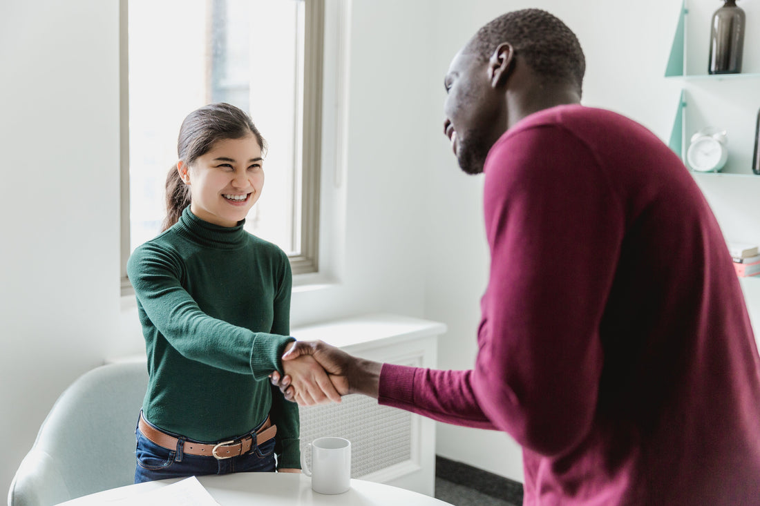 woman and man shaking hands 