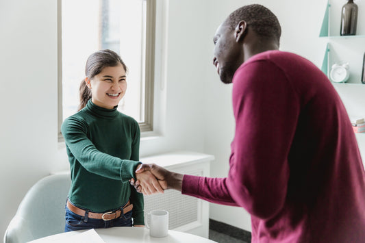 woman and man shaking hands 