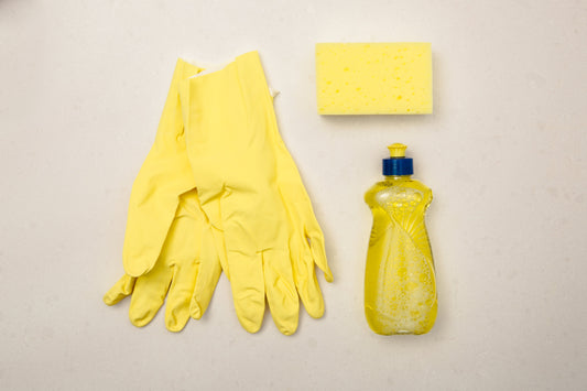yellow sponge, rubber gloves and washing up liquid 
